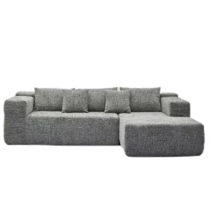 Modern Grey Modular Sofa with Chaise Lounge Description: A full frontal shot of a stylish, modern grey modular sofa with a chaise lounge on the right, featuring multiple cushioned backrests and a textured fabric finish, against a white background.